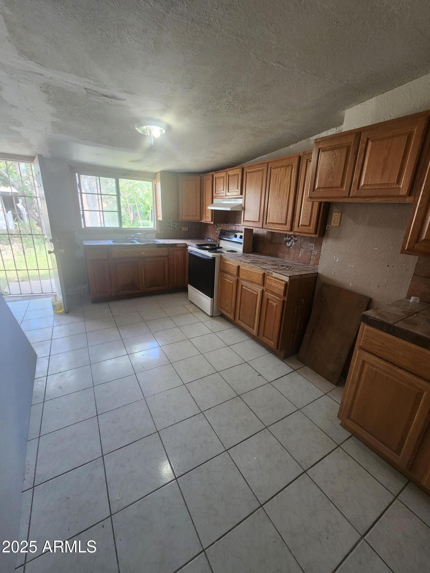730 1st Street Douglas, AZ 85607 - Photo 13 of 13 a kitchen with a sink a counter top space and appliances