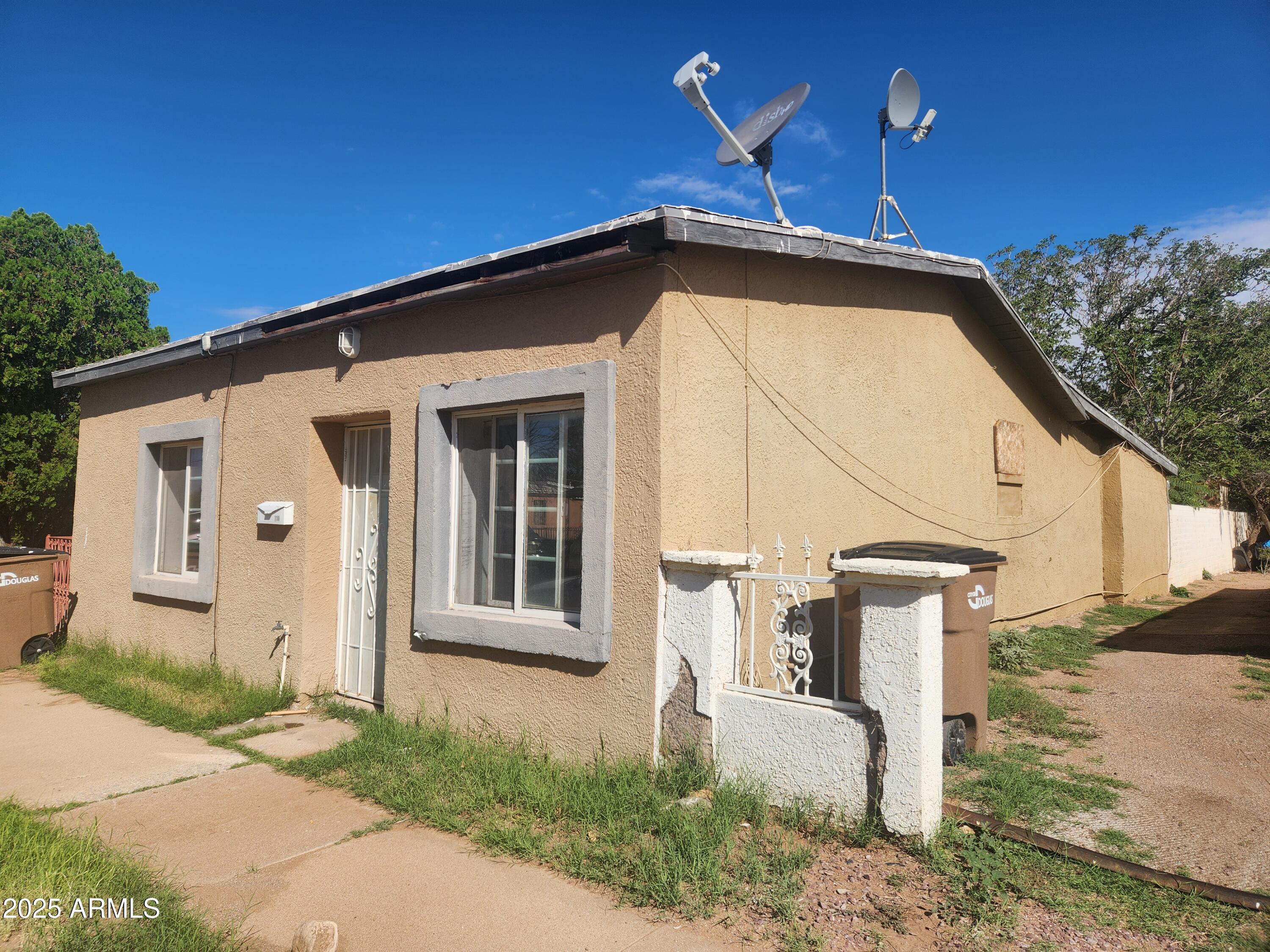 730 1st Street Douglas, AZ 85607 - Photo 2 of 13 a front view of a house with garden