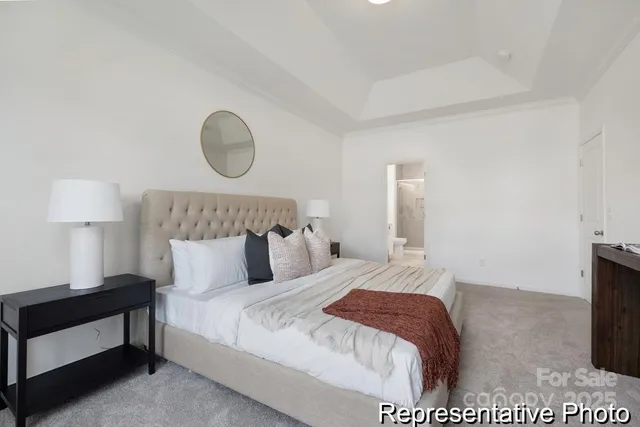 a bedroom with a bed and a lamp on table