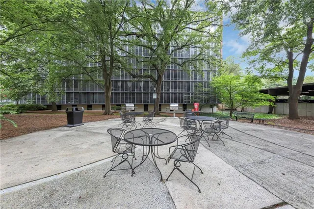 a view of patio with table and chairs under an umbrella