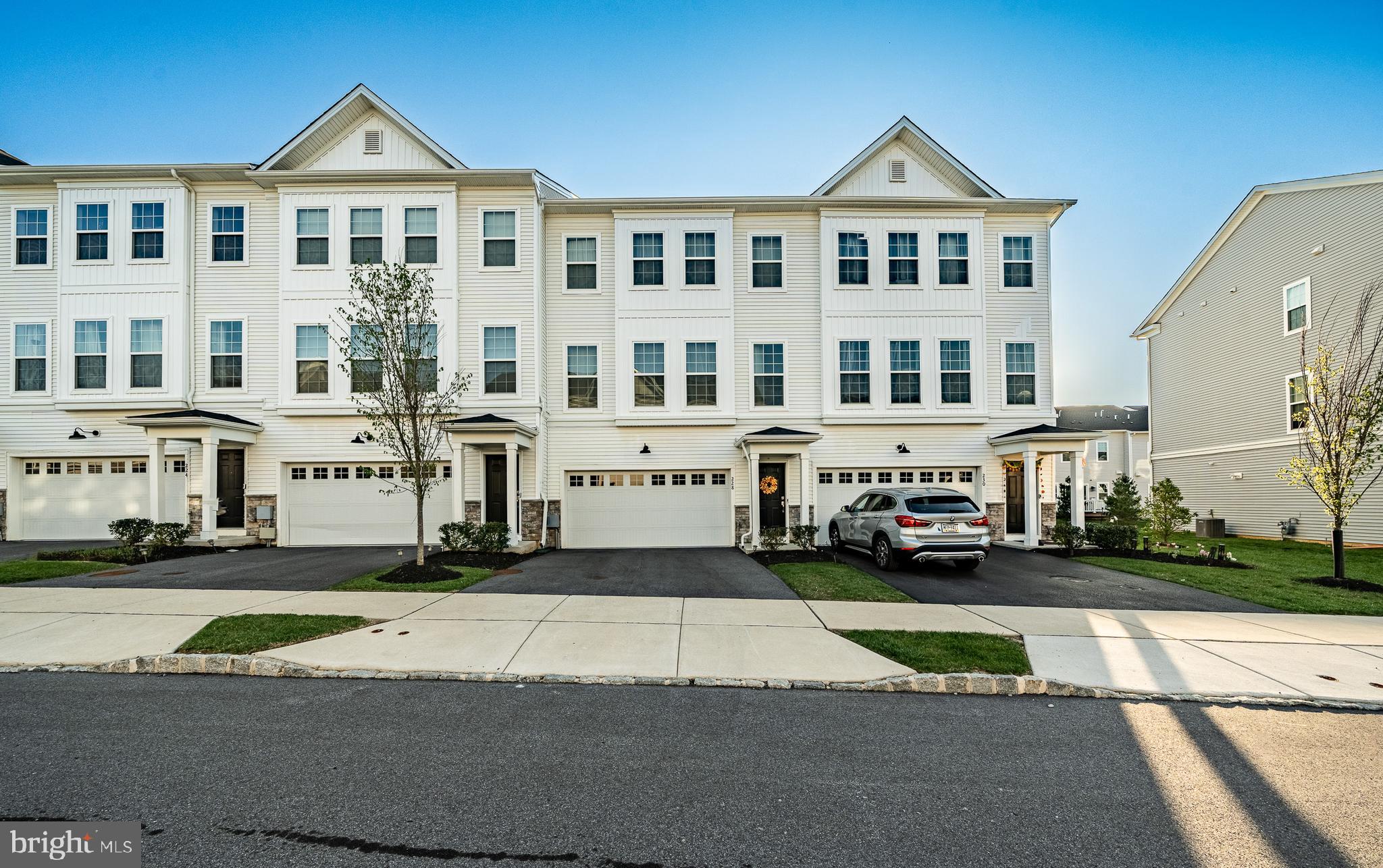 a front view of a residential apartment building with a yard