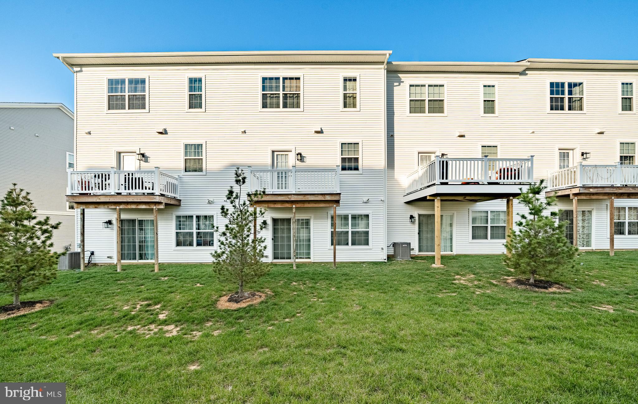 228 Red Leaf Lane Exton, PA 19341 - Photo 26 of 26 a large white building with a yard and plants