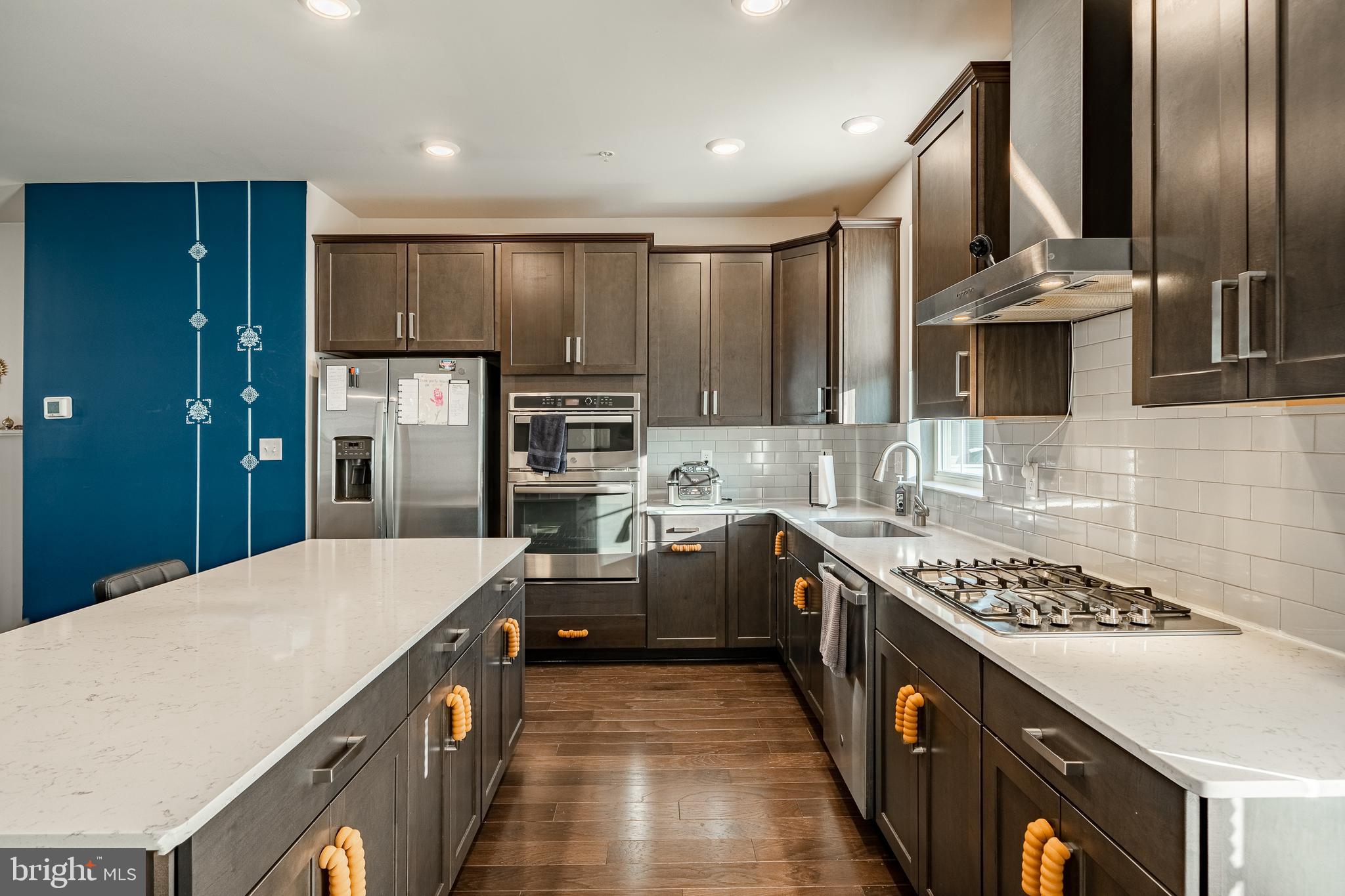 228 Red Leaf Lane Exton, PA 19341 - Photo 7 of 26 a kitchen with kitchen island stainless steel appliances a sink stove and refrigerator
