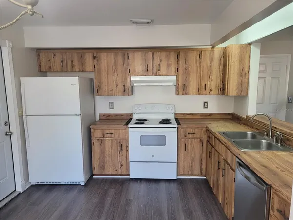 a kitchen with a stove sink and refrigerator