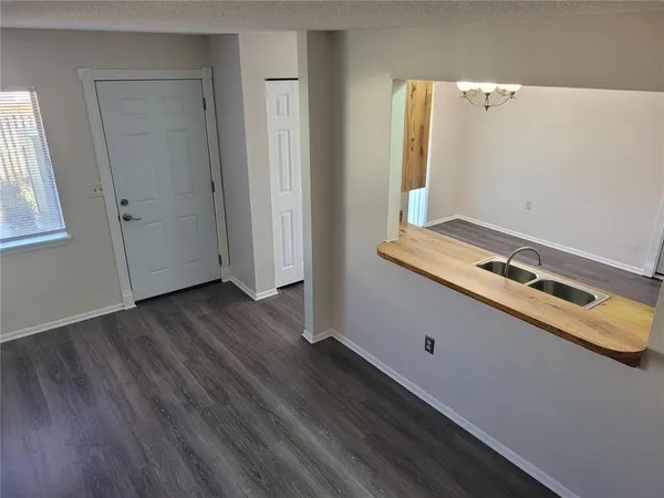 a room with wooden floor and white walls