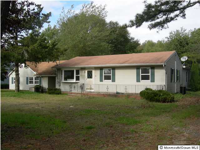 11 Bark Road Brick, NJ 08723 - Photo 1 of 3 a front view of a house with a garden