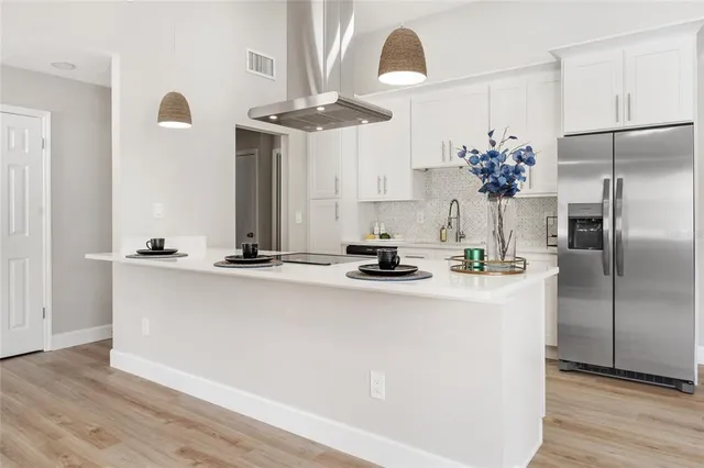 a kitchen with a sink and refrigerator