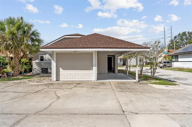 a front view of a house with a garden and yard