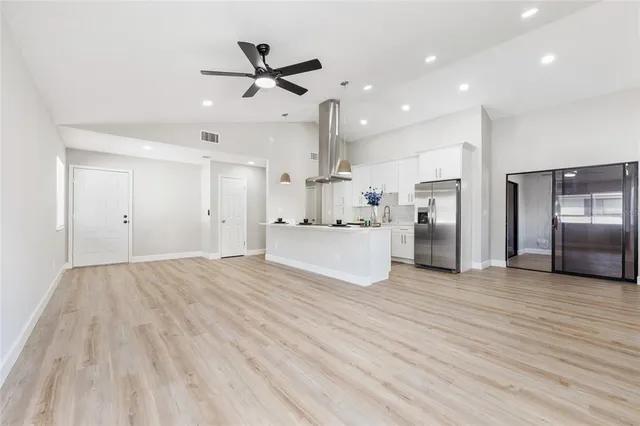 a view of a kitchen with a sink and stainless steel appliances