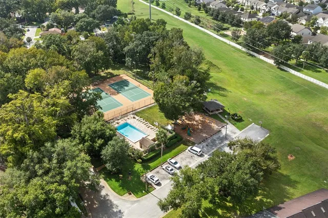 an aerial view of residential houses with outdoor space