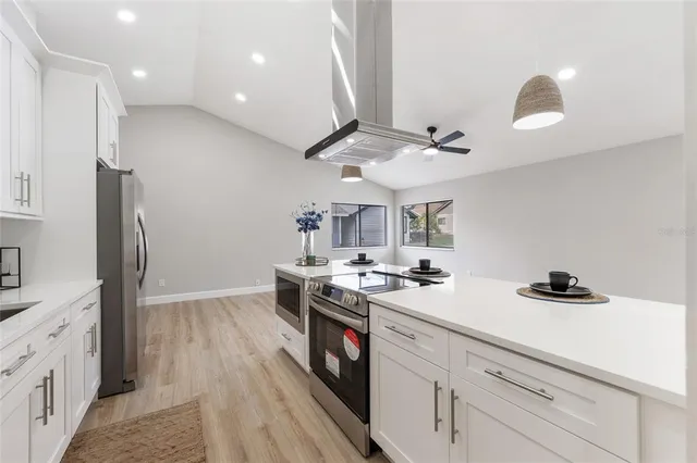 a kitchen with a stove a sink and a refrigerator