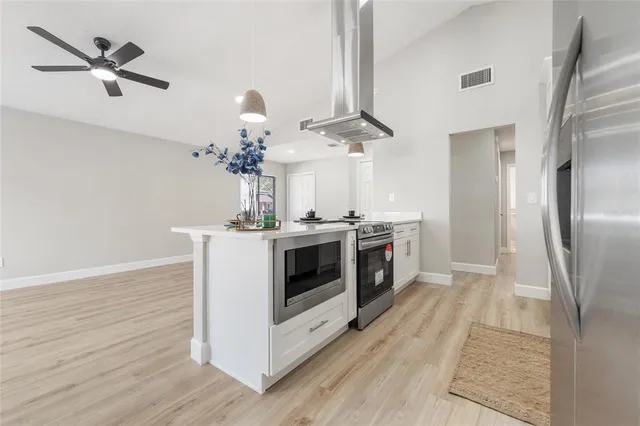 a kitchen with a white cabinets and stainless steel appliances