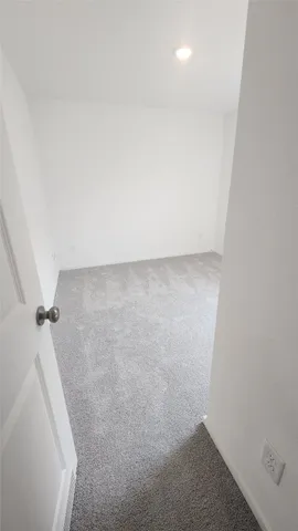 a front view of house with yard and trees in the background