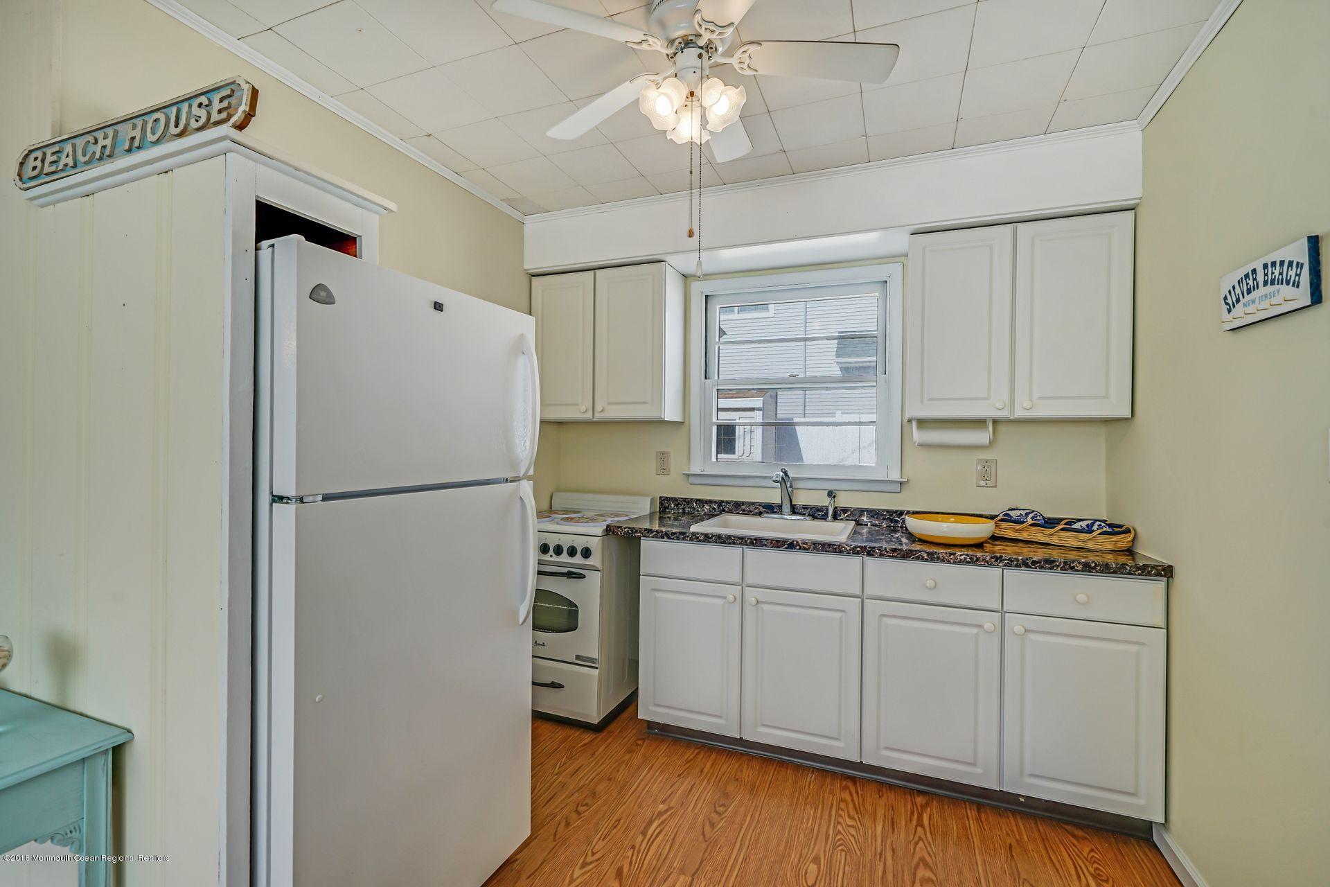 124 South Bayside Road Lavallette, NJ 08735 - Photo 15 of 26 a kitchen with stainless steel appliances a refrigerator a sink and a stove