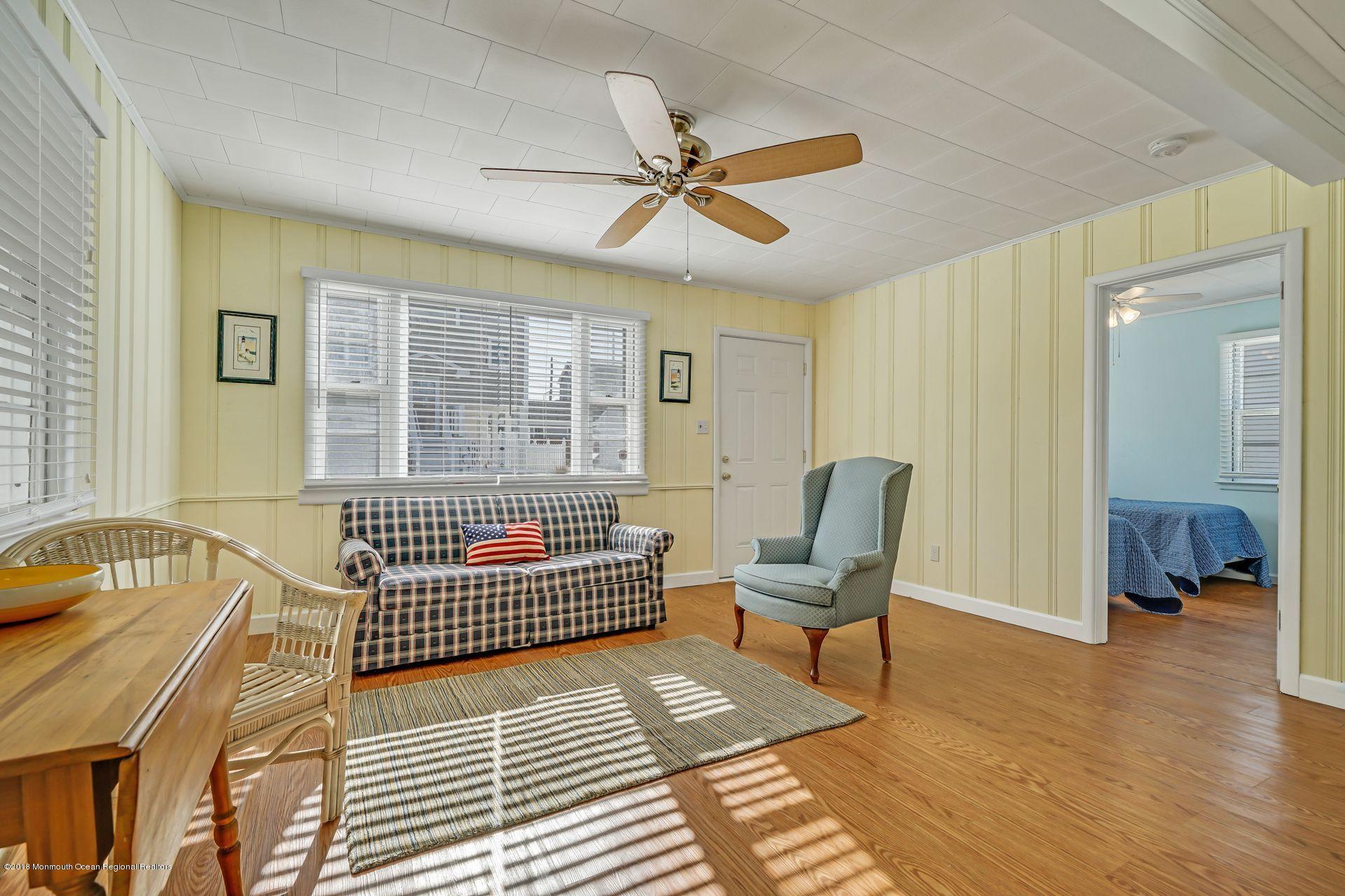 124 South Bayside Road Lavallette, NJ 08735 - Photo 5 of 26 a bedroom with a bed and wooden floor