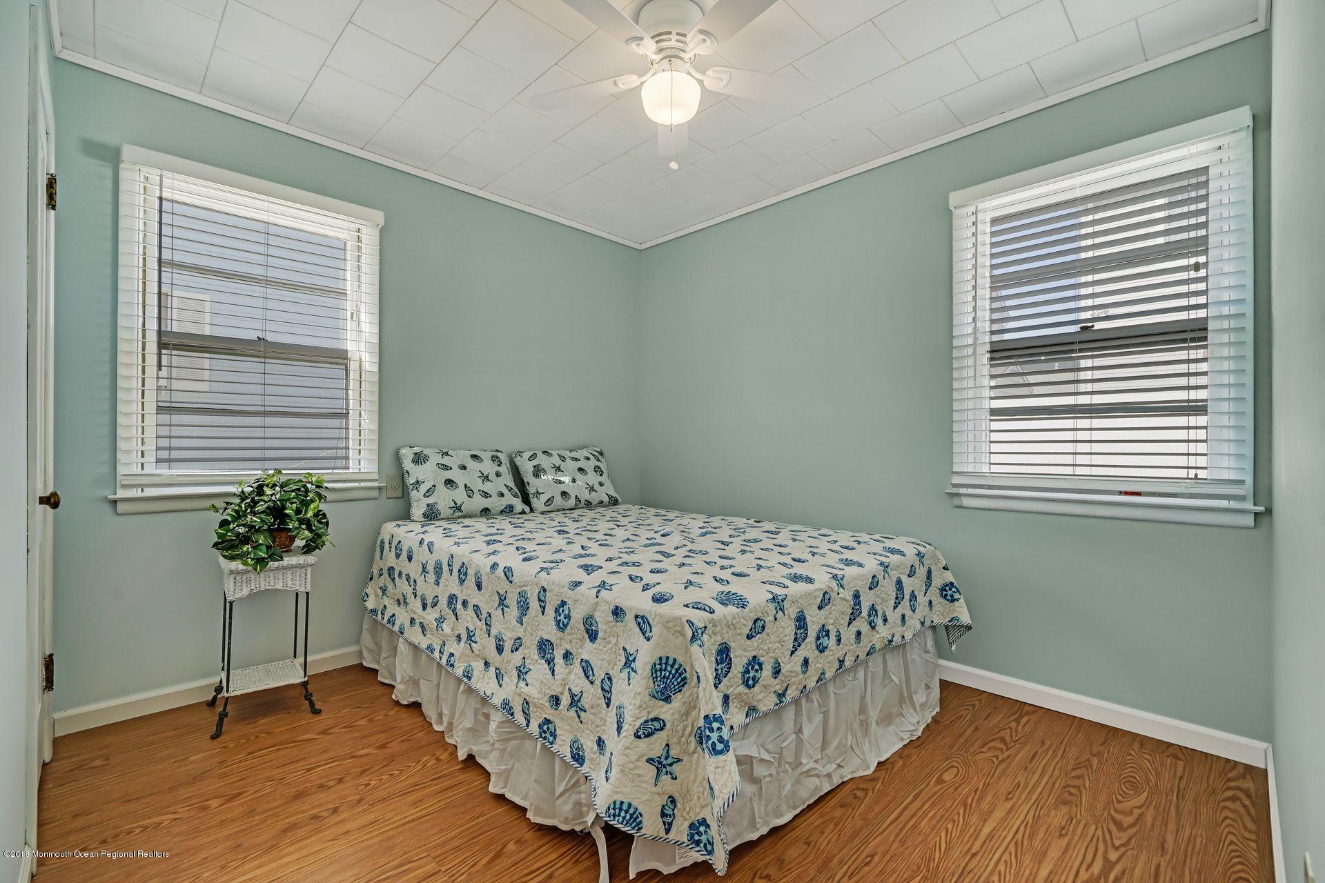 124 South Bayside Road Lavallette, NJ 08735 - Photo 7 of 26 a bedroom with a bed and a window