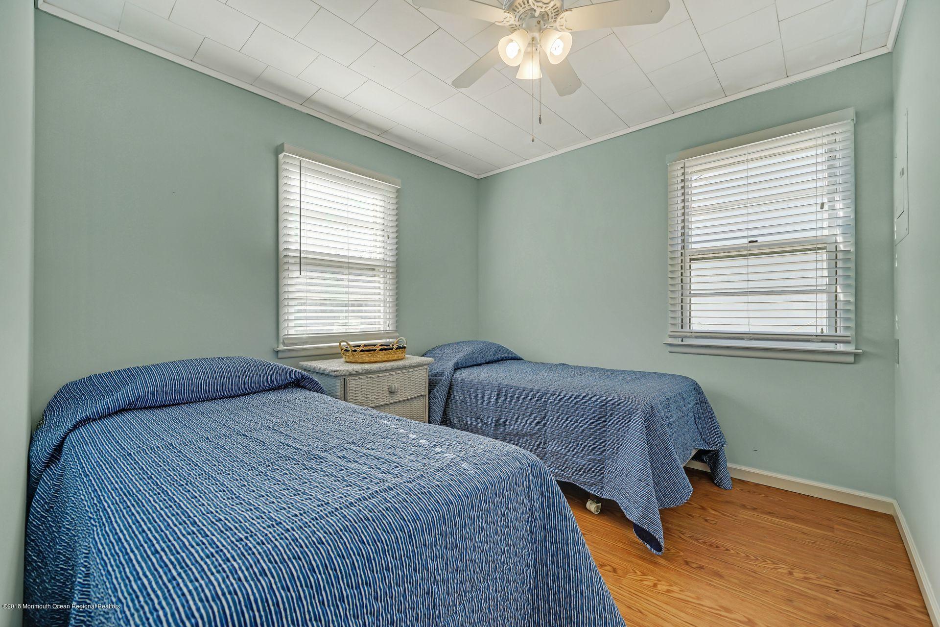 124 South Bayside Road Lavallette, NJ 08735 - Photo 8 of 26 a bedroom with two beds and a window