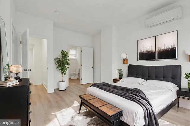 a bedroom with a bed and potted plant
