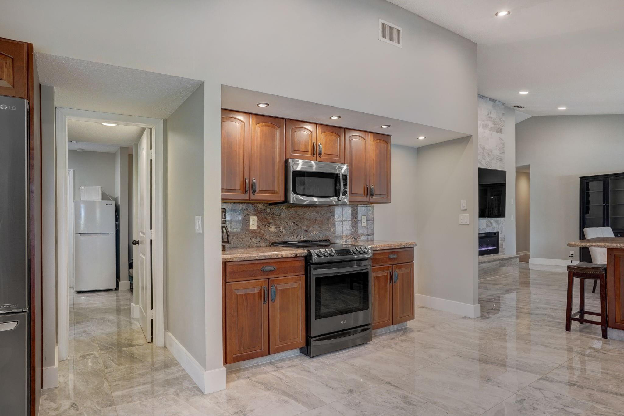 10377 185th Street South Boca Raton, FL 33498 - Photo 13 of 47 Hallway leads to in-law suite and garage