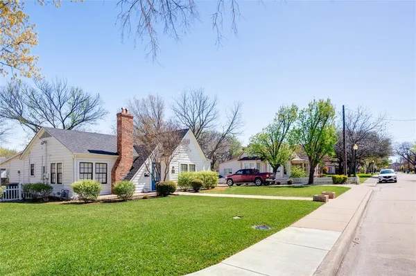 a view of yard with tree and wooden fence