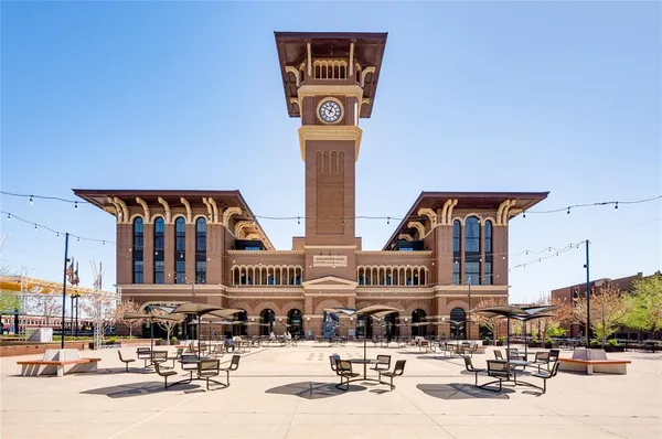 front view of a building with a lot of cars parked on the road