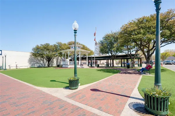a view of a house with a yard and large tree