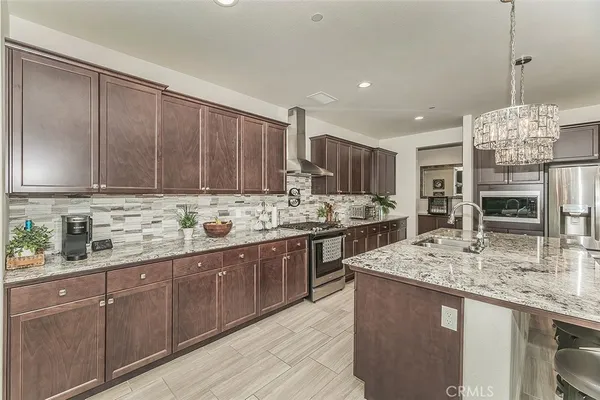 a kitchen with stainless steel appliances granite countertop sink stove and cabinets