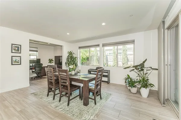 a living room with lots of furniture and kitchen view