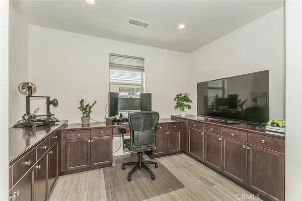 a view of a livingroom with workspace and a window
