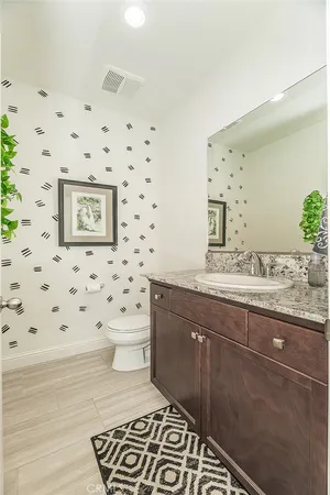 a bathroom with a sink double vanity granite tub and a mirror