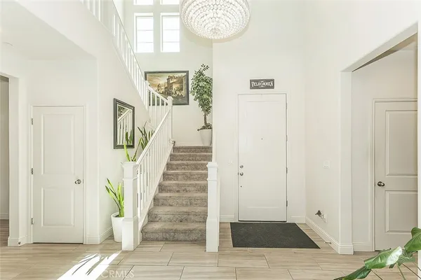 a bedroom with bed and a chandelier