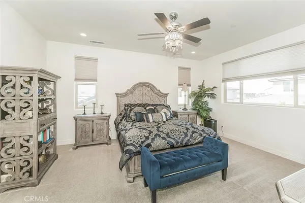 a bedroom with furniture and a chandelier
