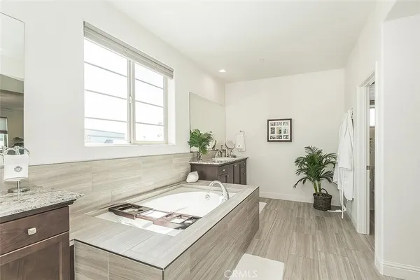 a spacious bathroom with a granite countertop sink and a window
