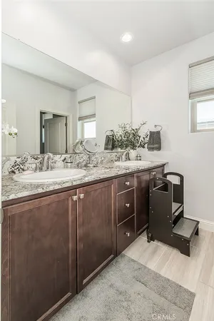a view of a patio with table and chairs with wooden floor and fence