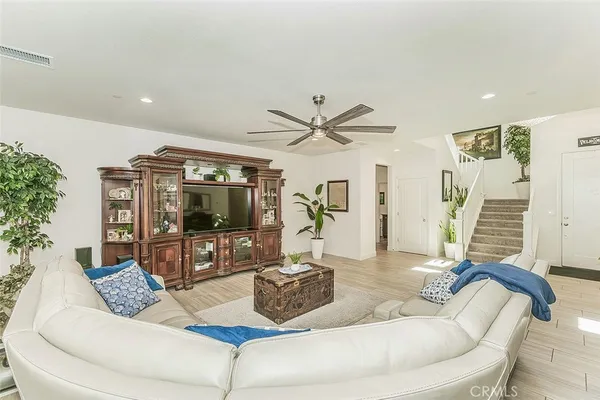 a kitchen with stainless steel appliances kitchen island granite countertop a table chairs sink and cabinets