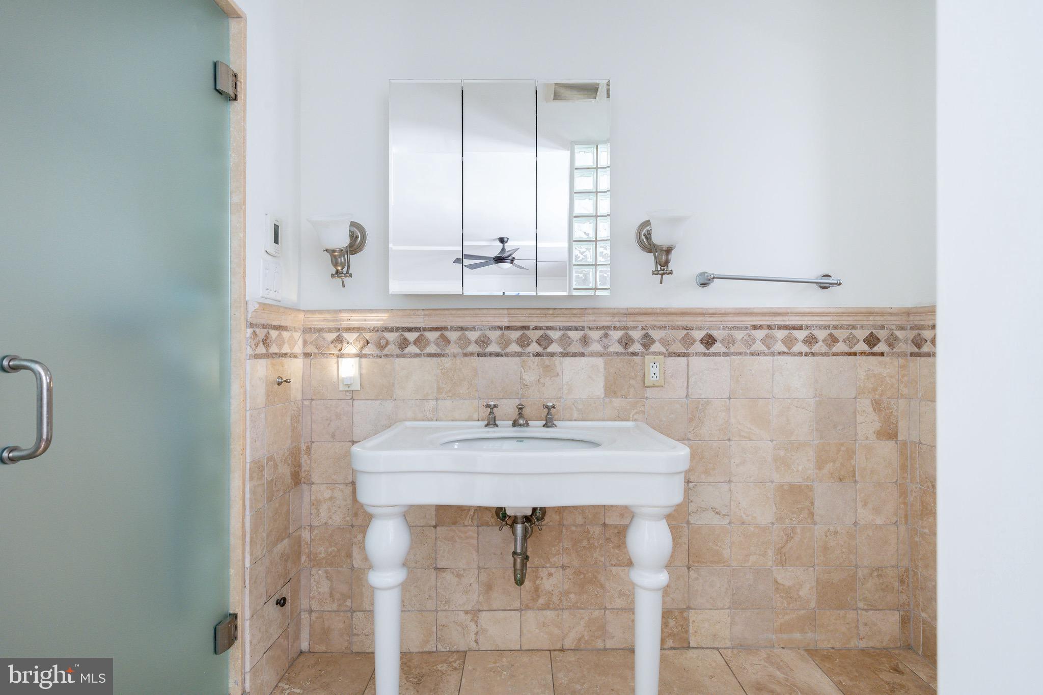 1901 Walnut Street, Unit 5E Philadelphia, PA 19103 - Photo 14 of 28 a bathroom with a sink and a mirror