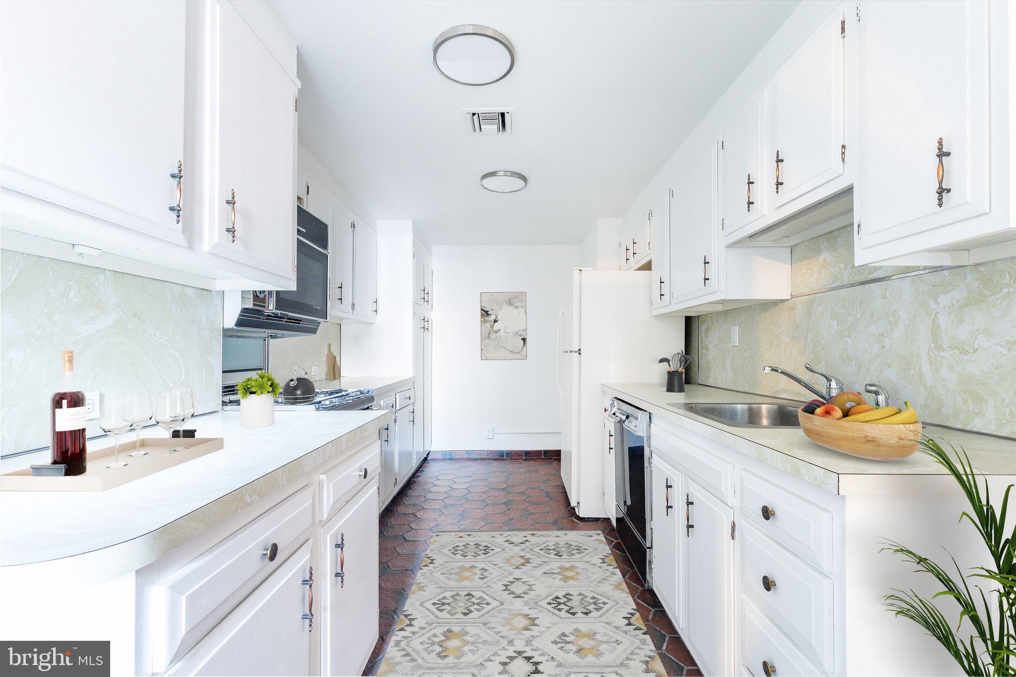 1901 Walnut Street, Unit 5E Philadelphia, PA 19103 - Photo 16 of 28 a kitchen with stainless steel appliances a sink a stove a refrigerator and white cabinets