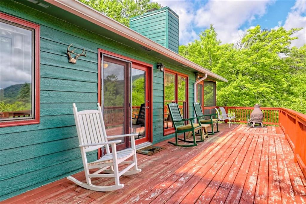 995 Glassy Mountain Road Hiawassee, GA 30546 - Photo 18 of 87 an outdoor sitting area with furniture and wooden floor