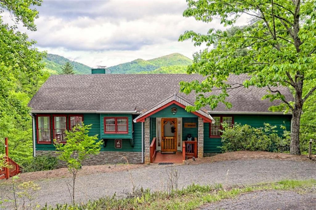995 Glassy Mountain Road Hiawassee, GA 30546 - Photo 2 of 87 a front view of a house with garden