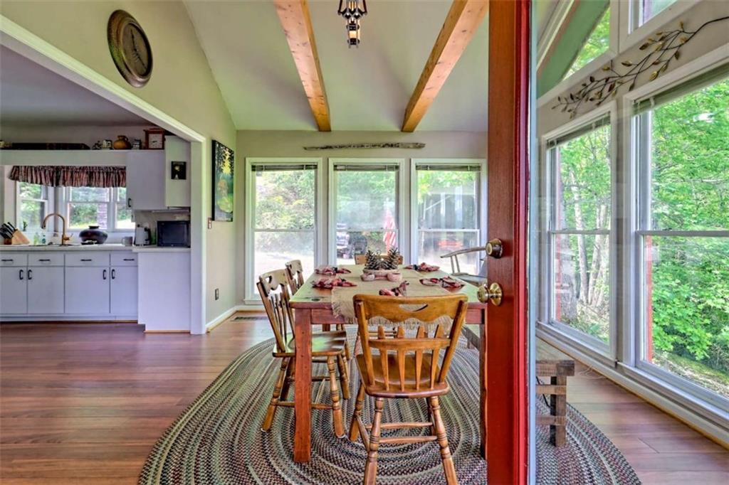995 Glassy Mountain Road Hiawassee, GA 30546 - Photo 33 of 87 a view of a dining room with furniture window and wooden floor