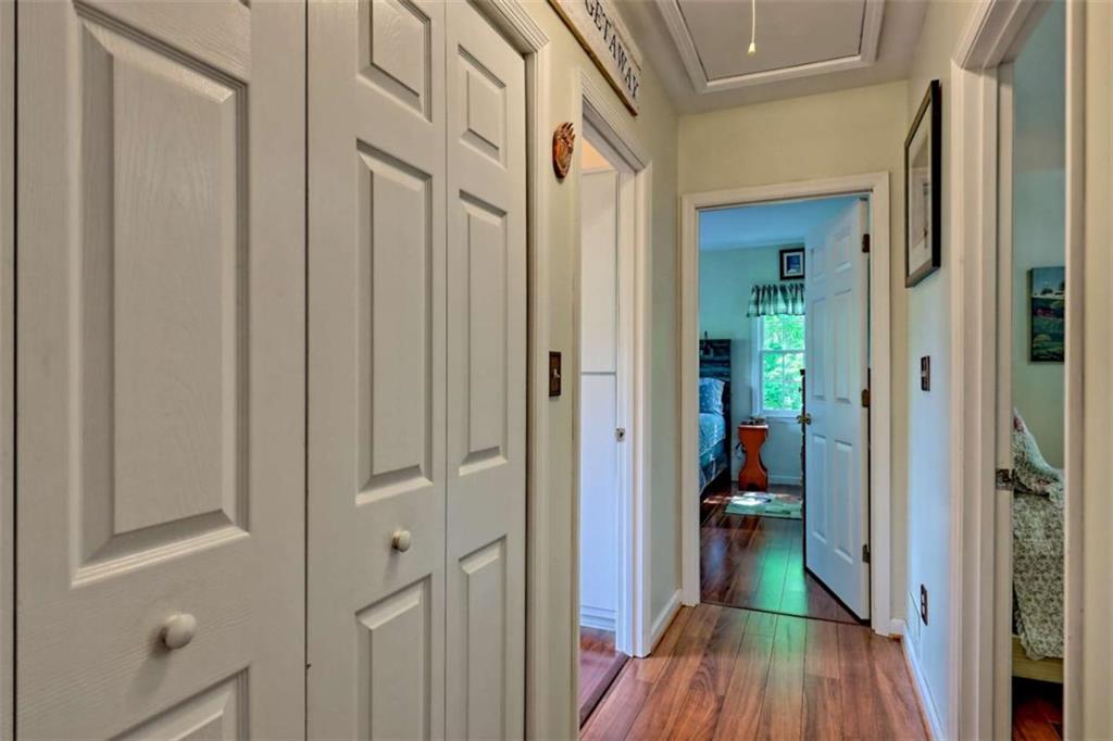 995 Glassy Mountain Road Hiawassee, GA 30546 - Photo 34 of 87 a view of a hallway with a livingroom and a bathroom with sink