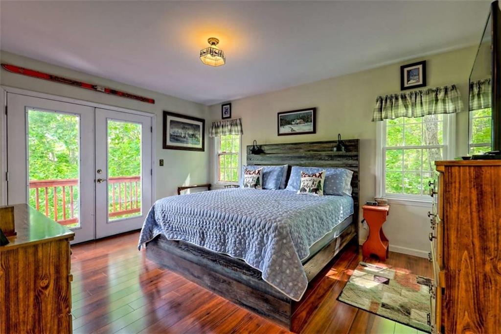 995 Glassy Mountain Road Hiawassee, GA 30546 - Photo 35 of 87 a bedroom with a bed and a window