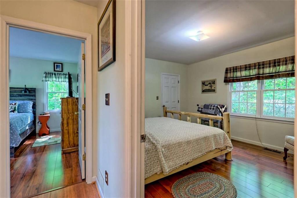 995 Glassy Mountain Road Hiawassee, GA 30546 - Photo 45 of 87 a bedroom with a bed and a large window with the outer view