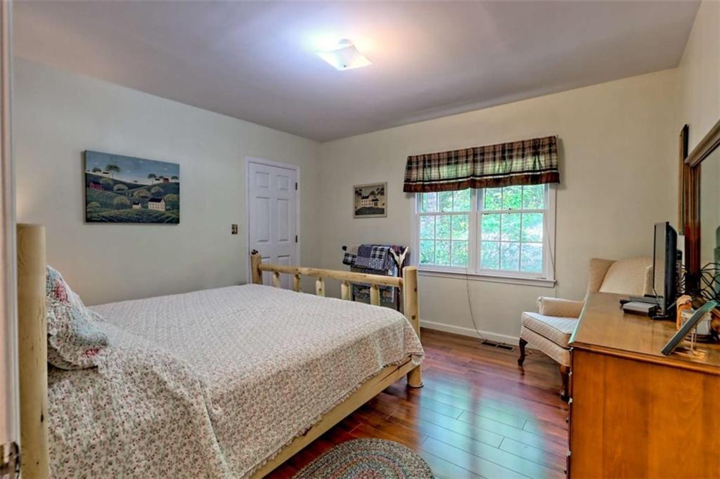 995 Glassy Mountain Road Hiawassee, GA 30546 - Photo 46 of 87 a bedroom with a bed window and a desk