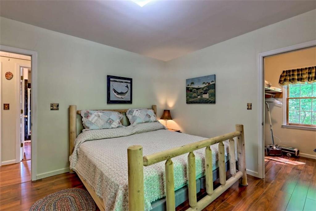 995 Glassy Mountain Road Hiawassee, GA 30546 - Photo 48 of 87 a bedroom with a bed and a wooden floor