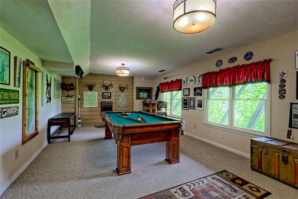 995 Glassy Mountain Road Hiawassee, GA 30546 - Photo 52 of 87 a room with musical instruments and wooden walls
