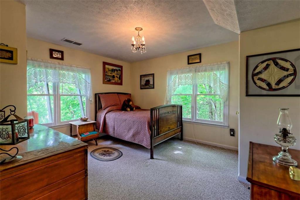 995 Glassy Mountain Road Hiawassee, GA 30546 - Photo 56 of 87 a bed room with a bed and a window