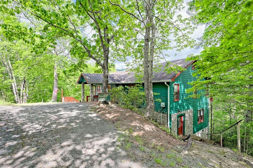995 Glassy Mountain Road Hiawassee, GA 30546 - Photo 6 of 87 a view of a house with a tree and a yard