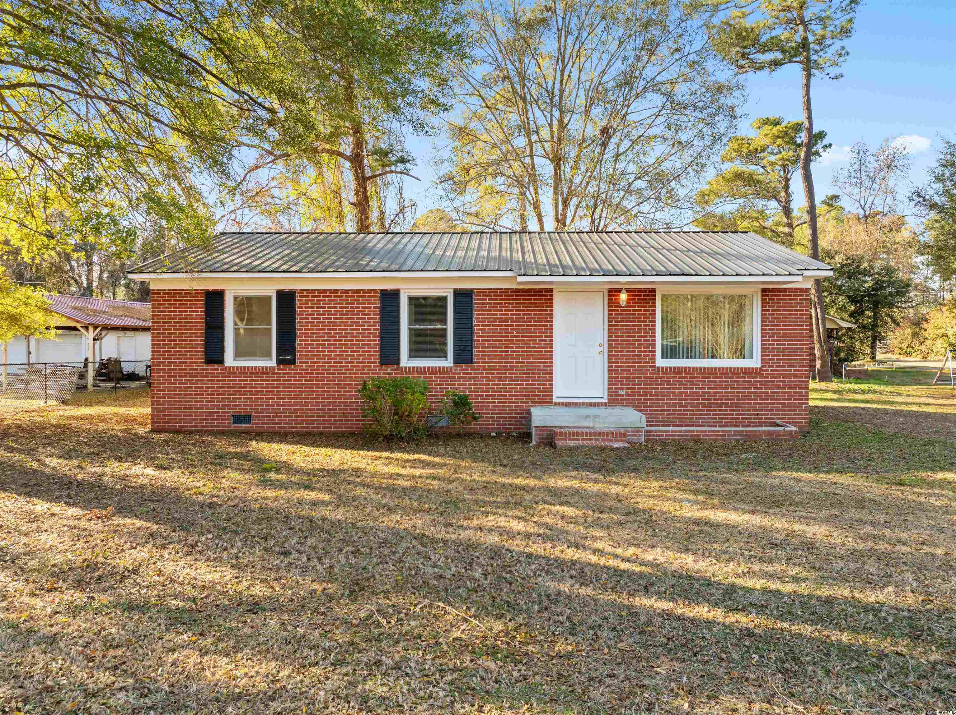 139 State Rd S-22-496 Andrews, SC 29510 - Photo 17 of 20 View of front of property with a metal roof, crawl space, a front lawn, and brick siding