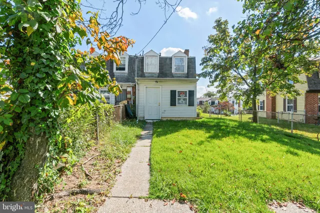 a front view of a building with a big yard